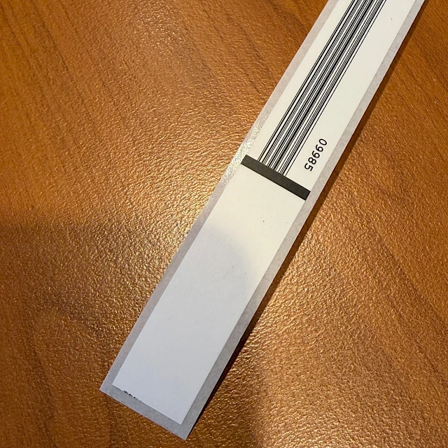 White backing card with black stripes on desk