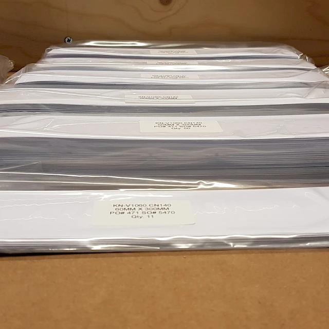 White card stacks in labelled poly bags