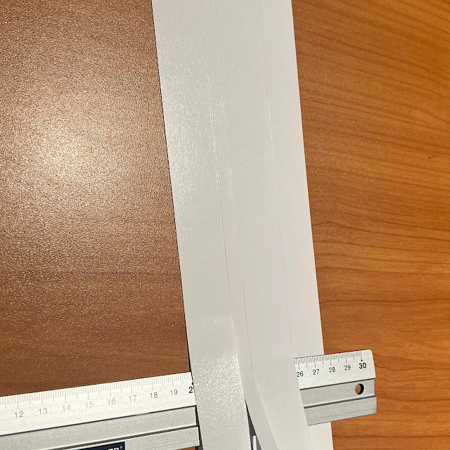 White card strips measured with ruler