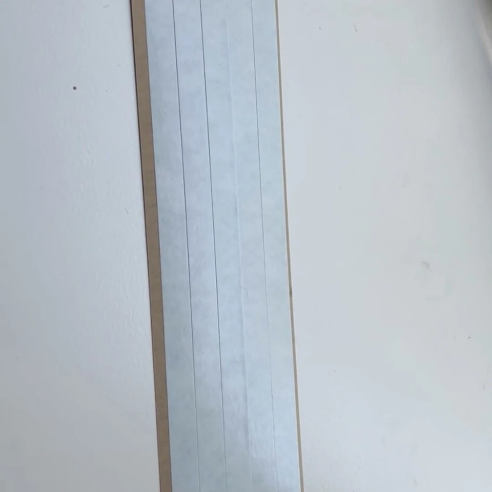 White card strips on brown liner