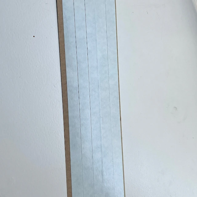 White card strips on brown liner