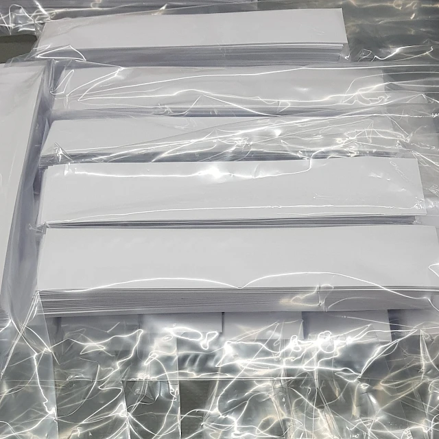White cards packed in clear plastic bags