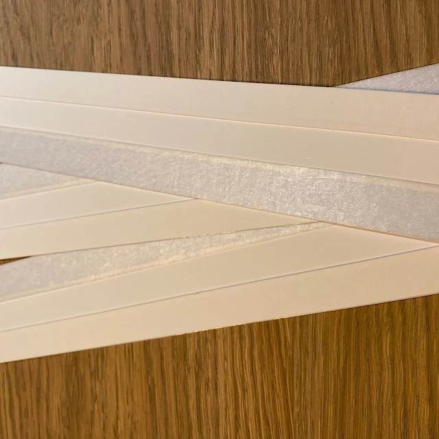 White cards with fibrous edge on wood