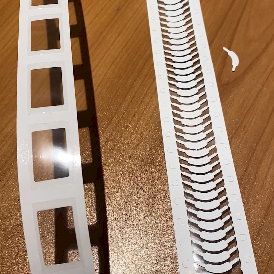 White die cut ladder and label strips on desk