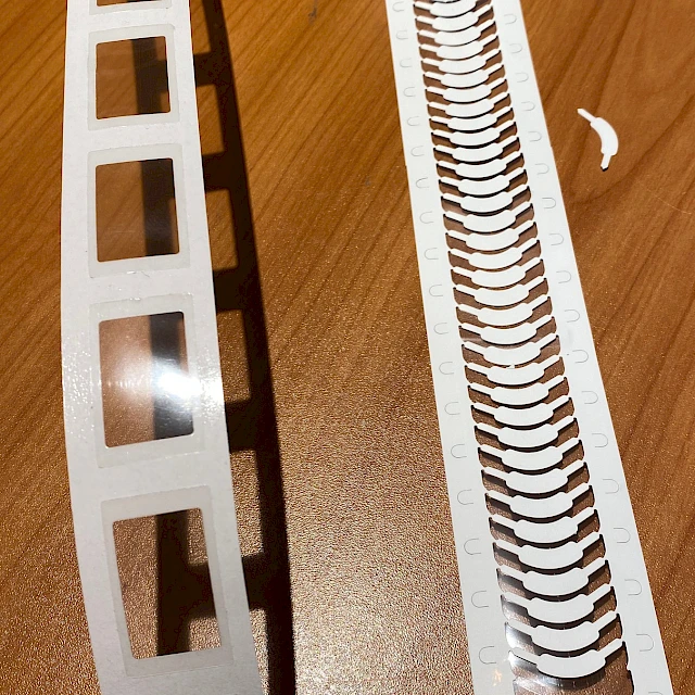 White die cut ladder and label strips on desk