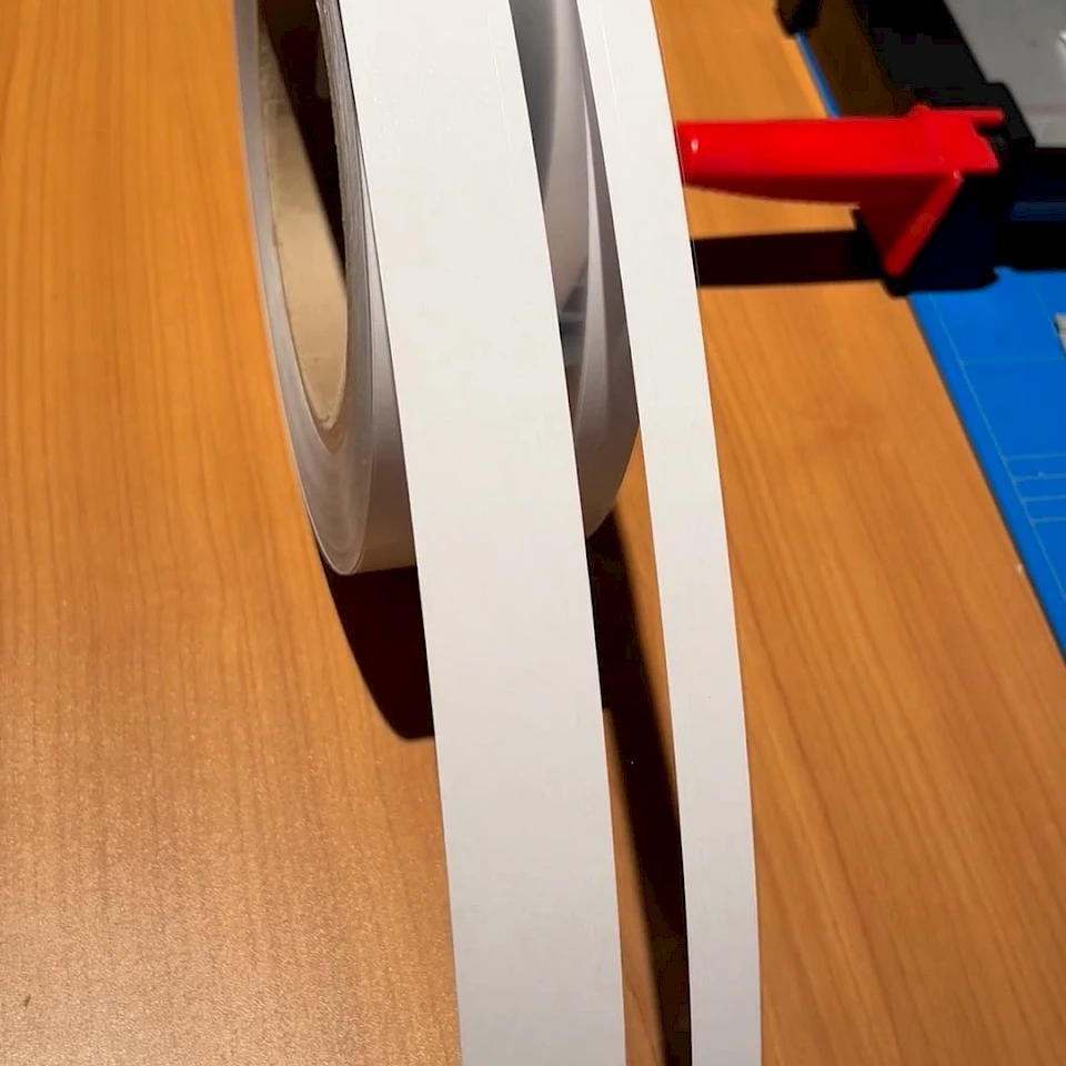 White grey tape roll unwound on desk