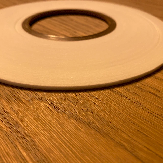 White narrow tape roll on wood