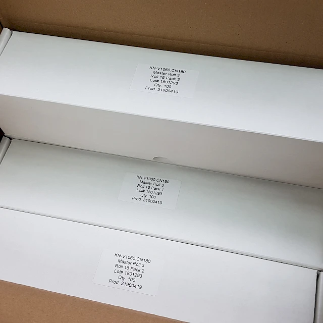 White product boxes stacked in open carton