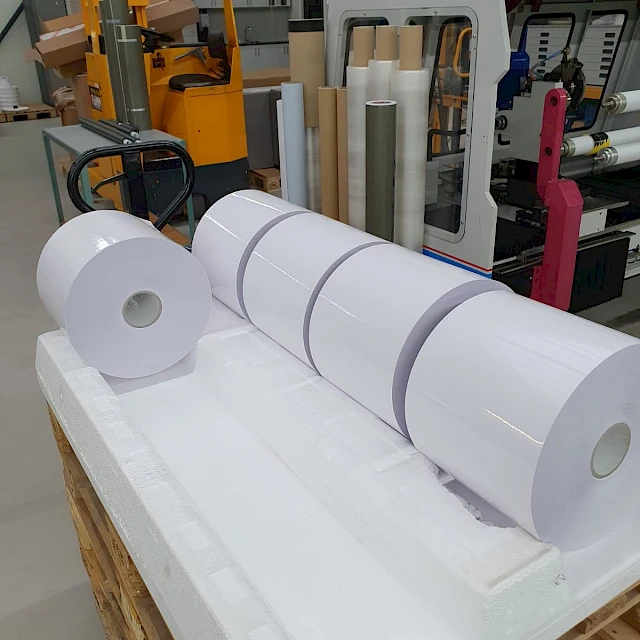 White rolls on foam pallet in factory