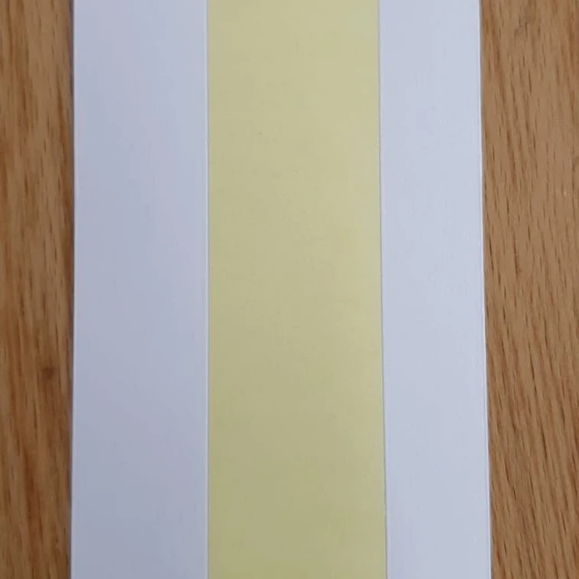 White strip with yellow adhesive center