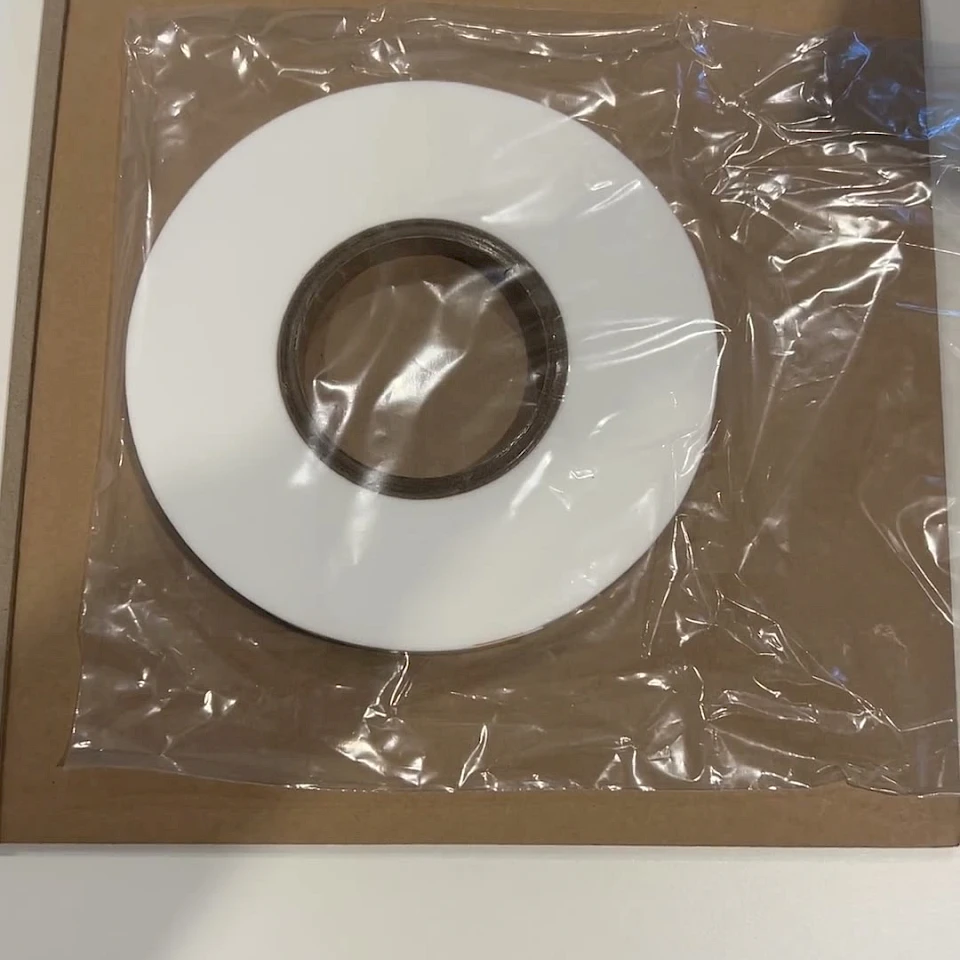 White tape roll bagged on cardboard tray