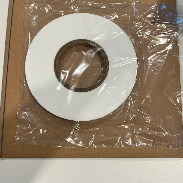 White tape roll bagged on cardboard tray