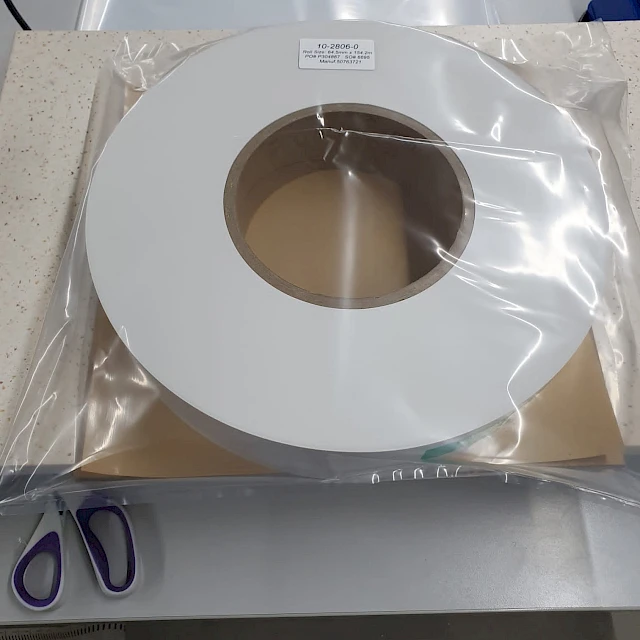 White tape roll in plastic bag with scissors