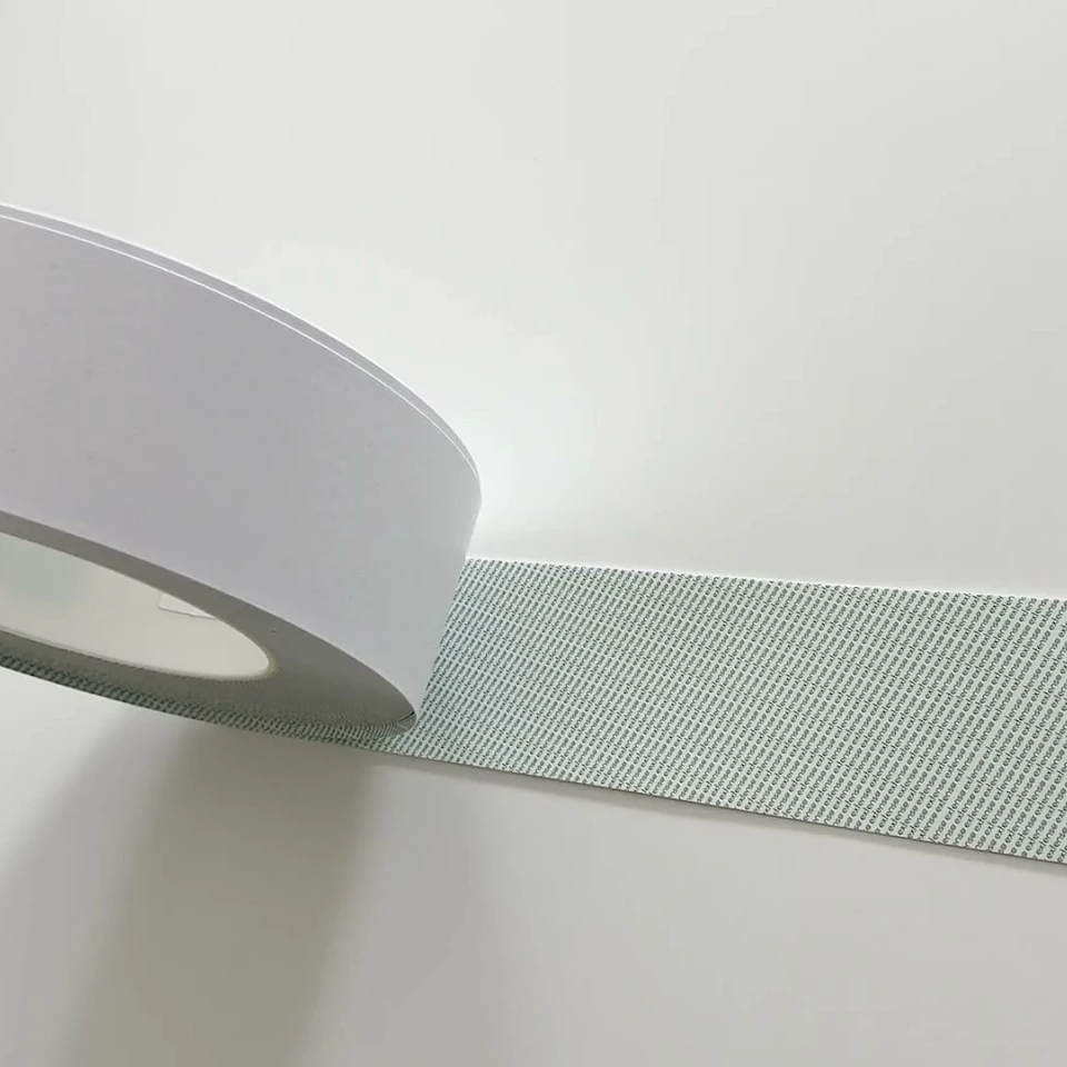 White tape roll with green grid sheet