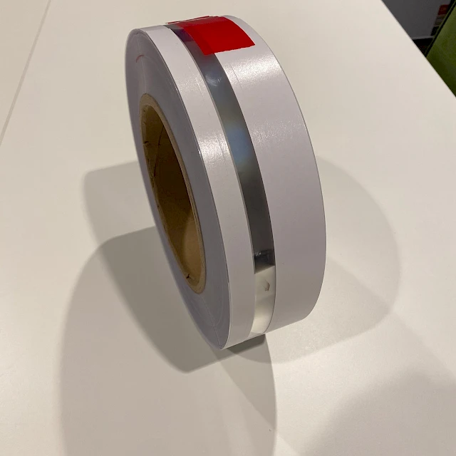 White tape roll with red marker standing