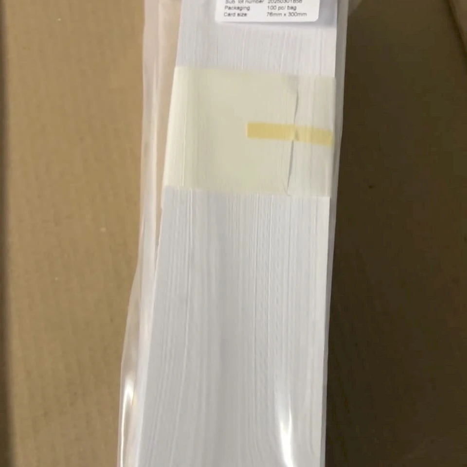 White vinyl card bundle in bag on carton