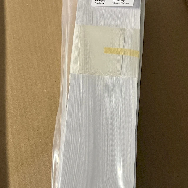 White vinyl card bundle in bag on carton