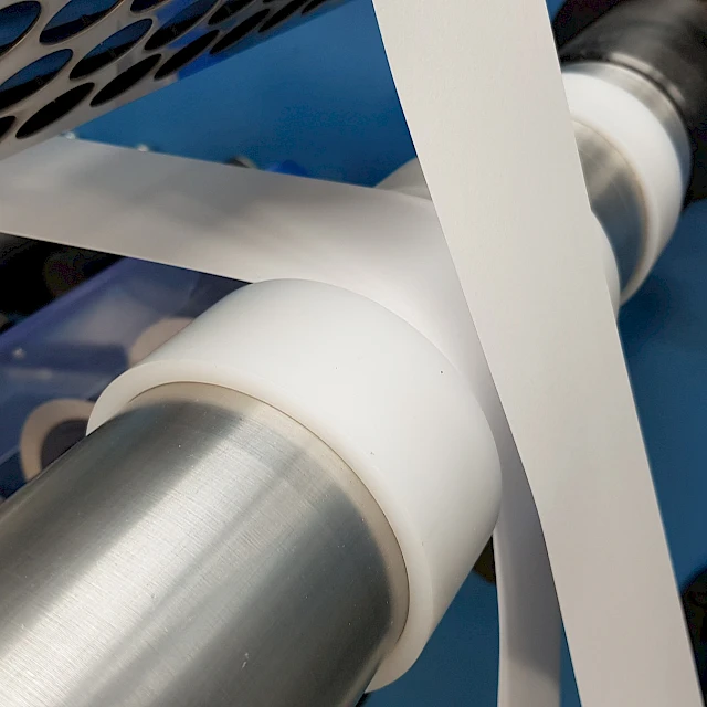 White web on machine rollers