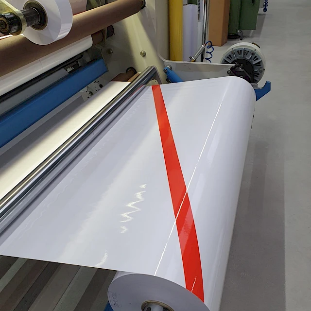 White web with red stripe on rewinder