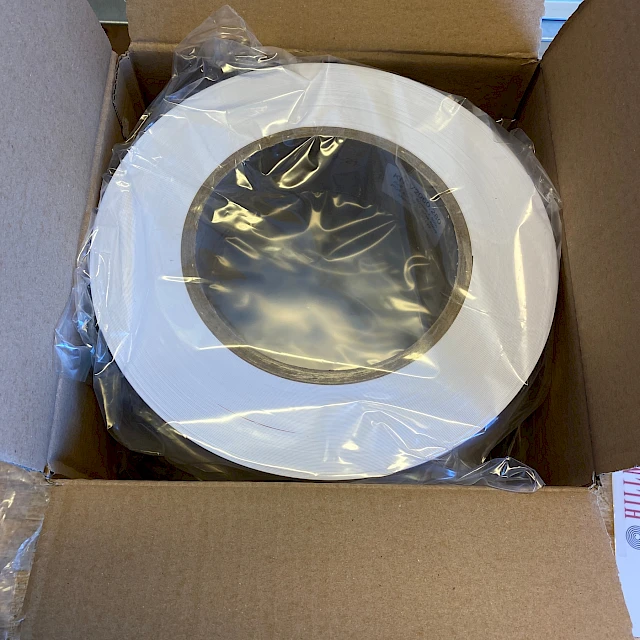 Wide white roll wrapped in open carton