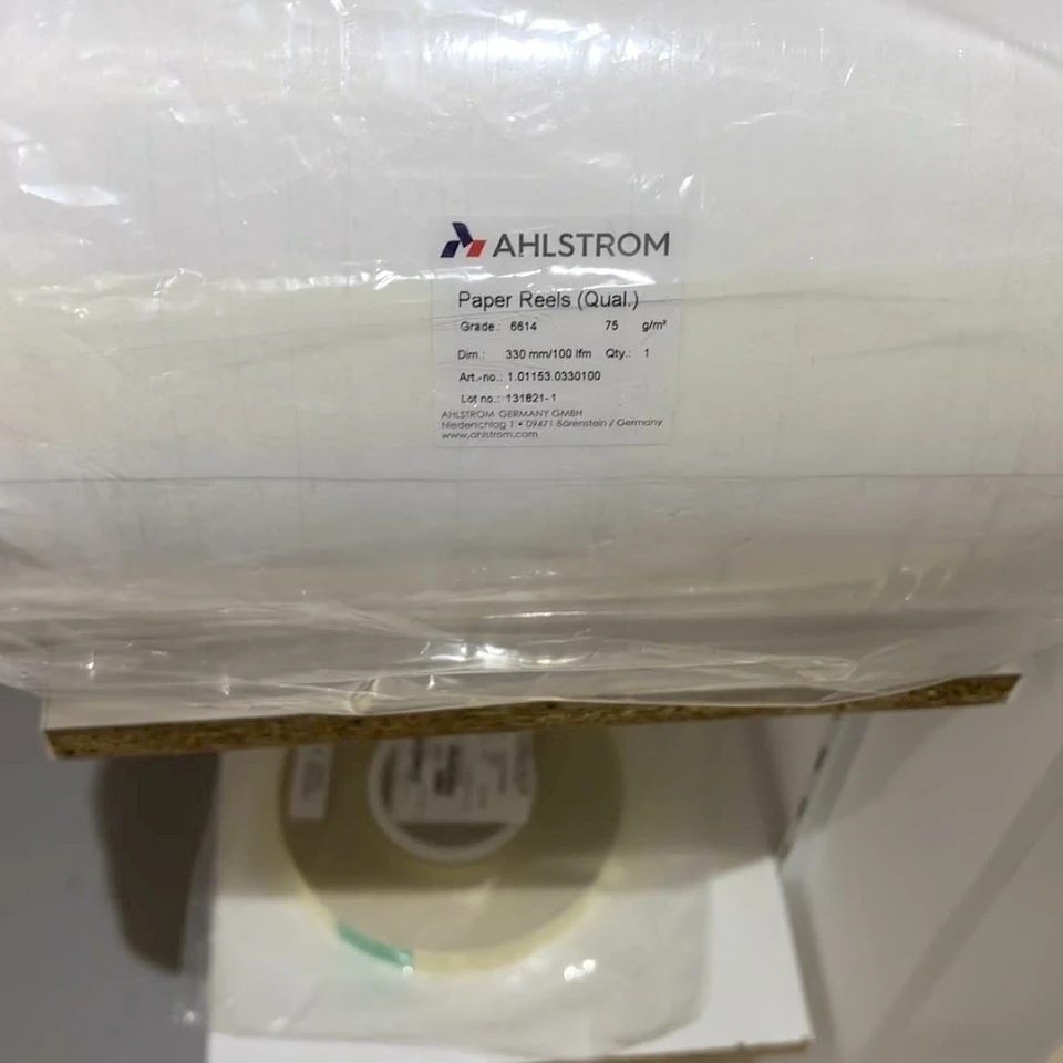 Wrapped paper reel with supplier label