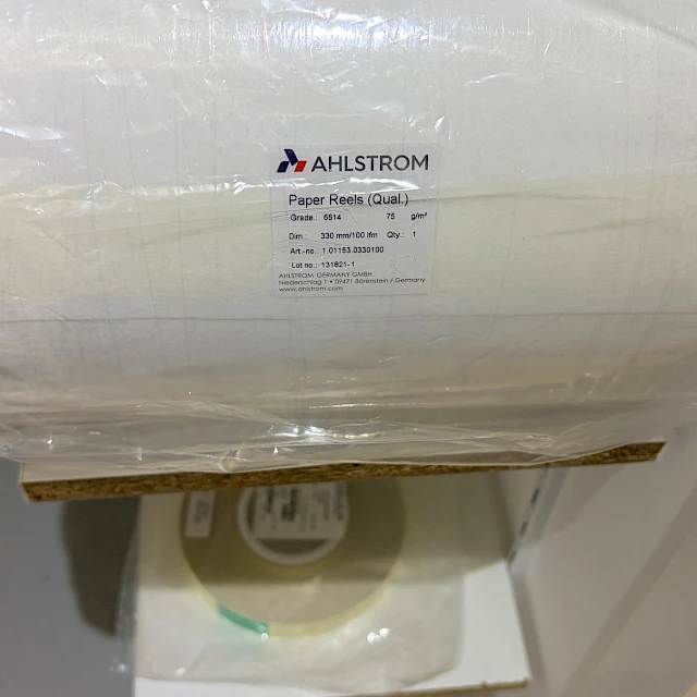 Wrapped paper reel with supplier label