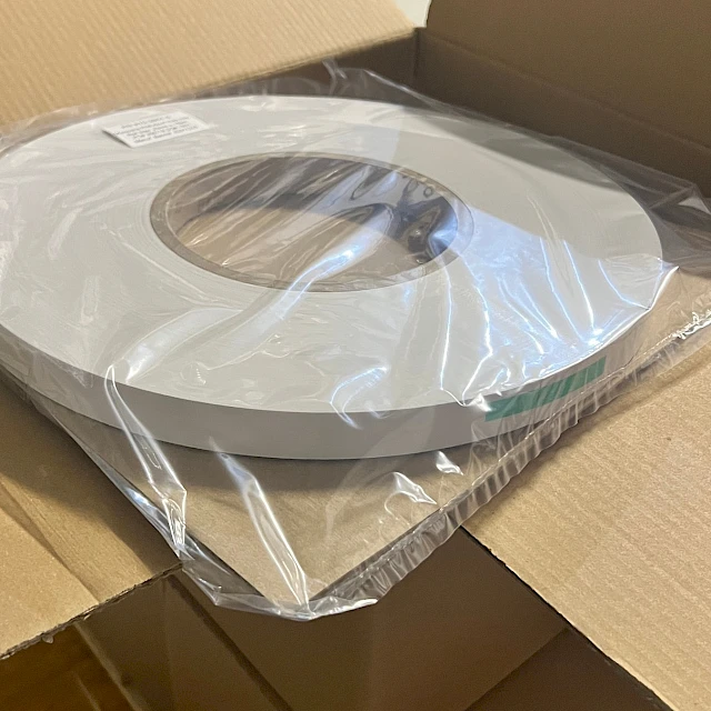 Wrapped white roll in open box warehouse