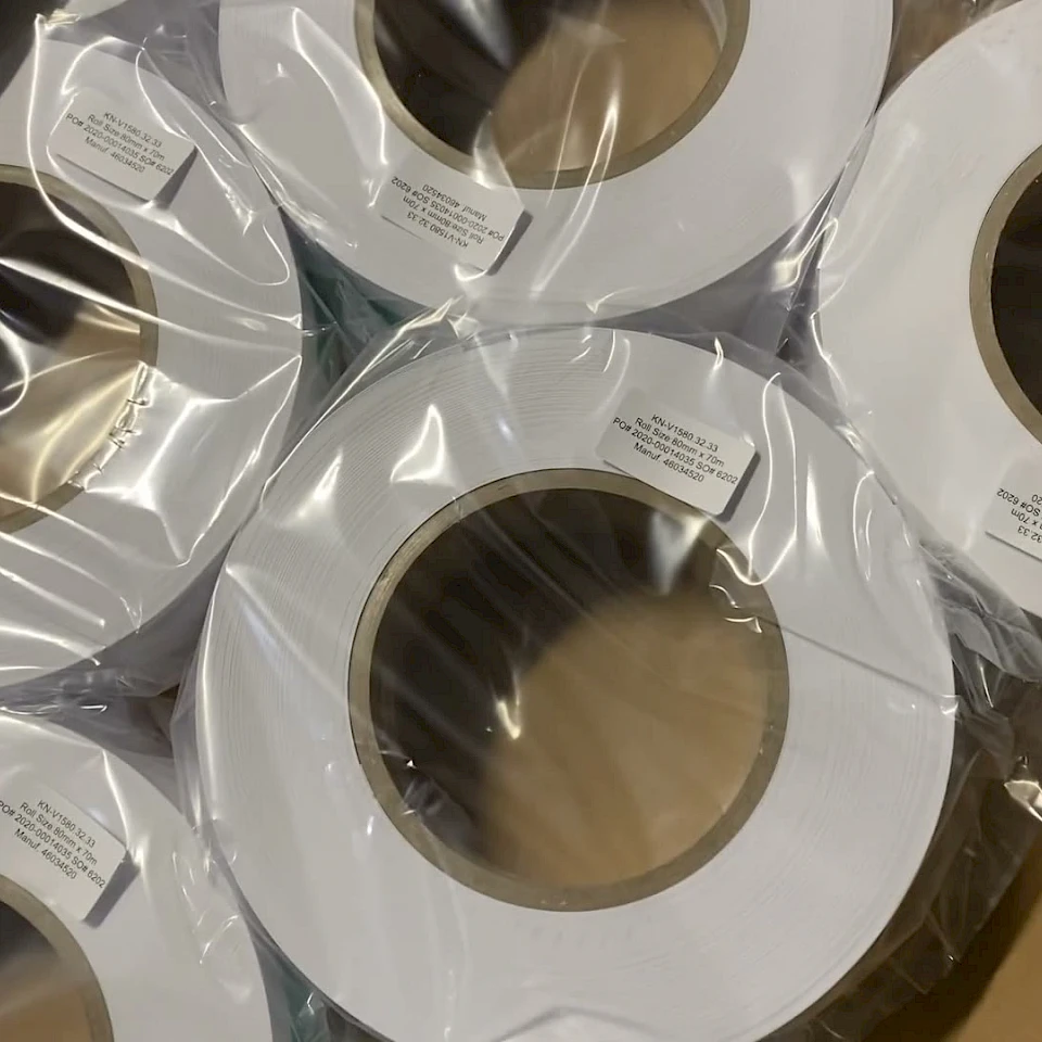 Wrapped white rolls in carton closeup