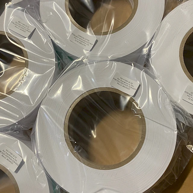 Wrapped white rolls in carton closeup