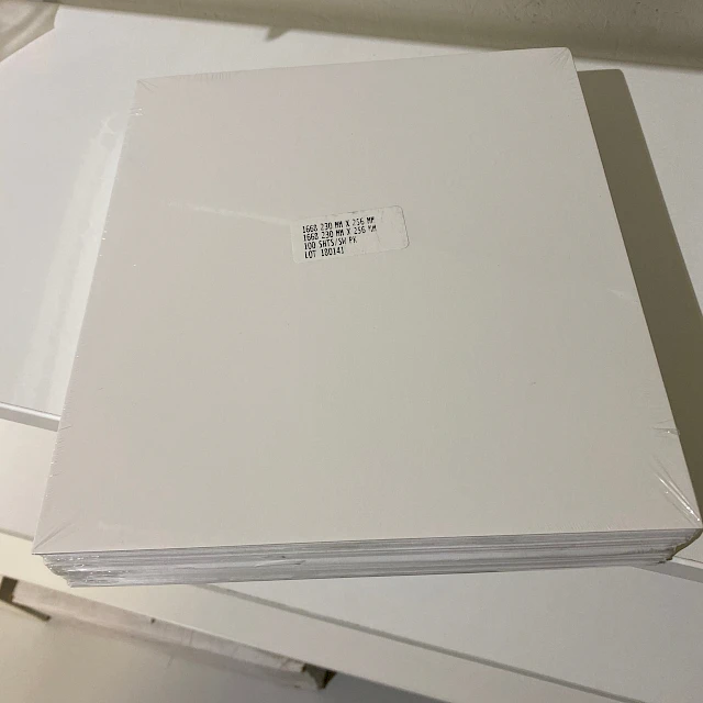 Wrapped white sheet stack on shelf