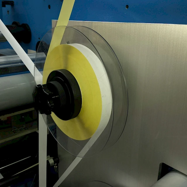 Yellow tape roll on slitter unwind disc