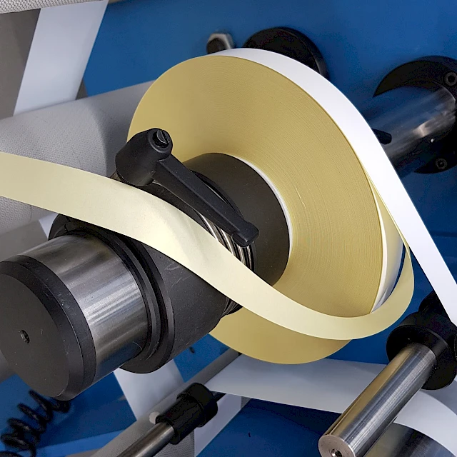 Yellow tape roll unwinding with liner strip